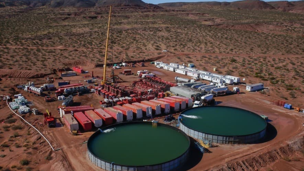 Oil production site with storage tanks and equipment in Vaca Muerta