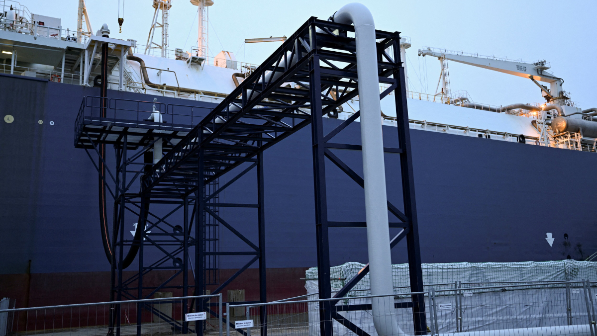 LNG vessel docked beside industrial loading structure during offshore operations.