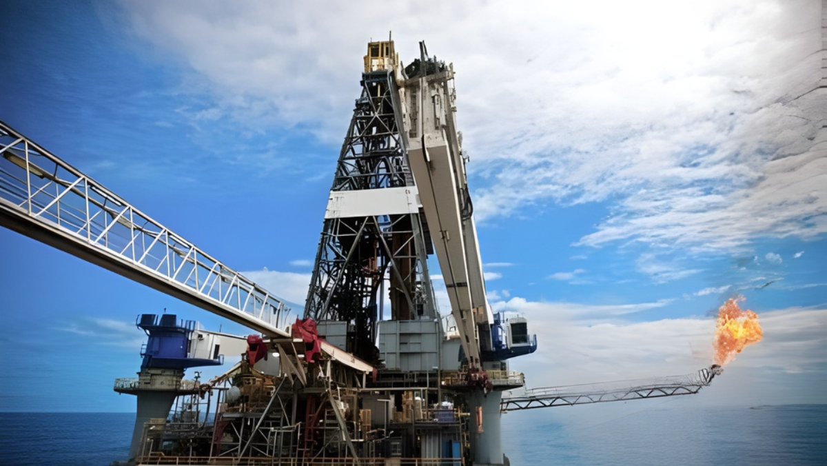 Offshore drilling platform with flare stack burning gas against a bright sky.
