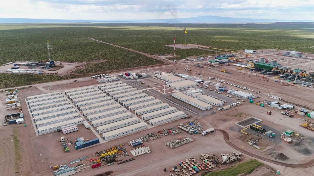 Aerial view of Vaca Muerta shale development site with camps and drilling pads