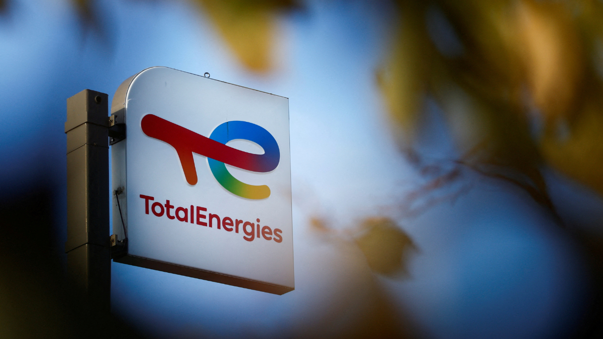 TotalEnergies logo on outdoor sign against blurred blue sky