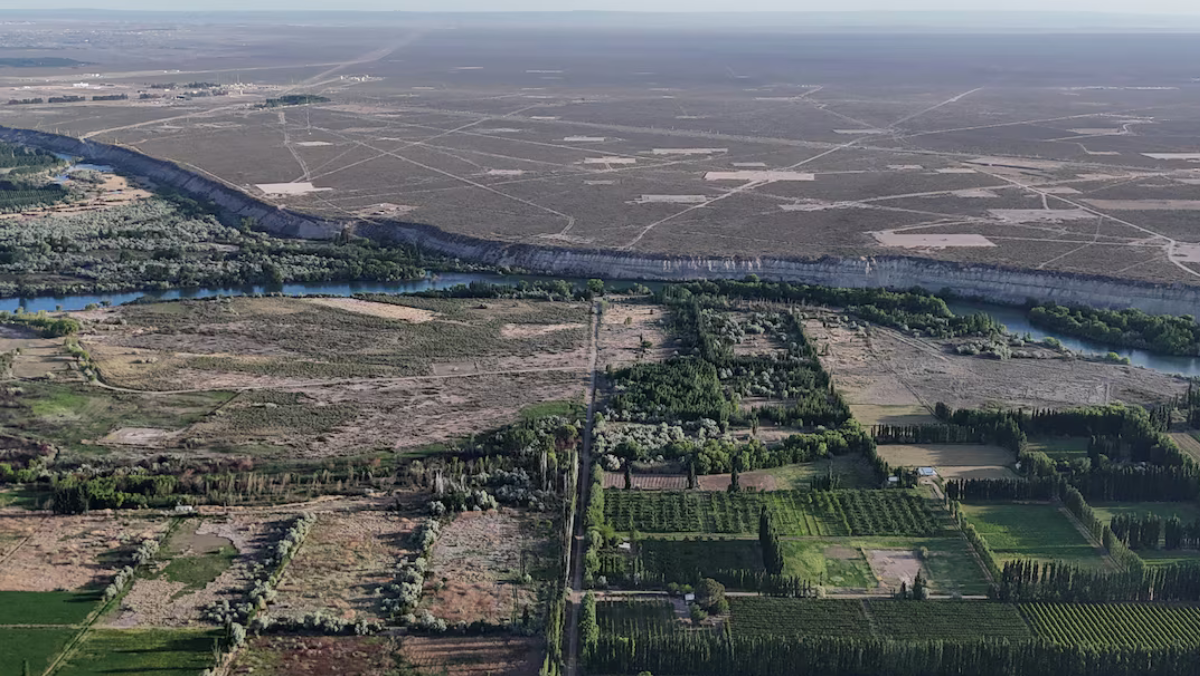 Aerial panorama of Argentina’s shale basin bordered by river and agricultural areas