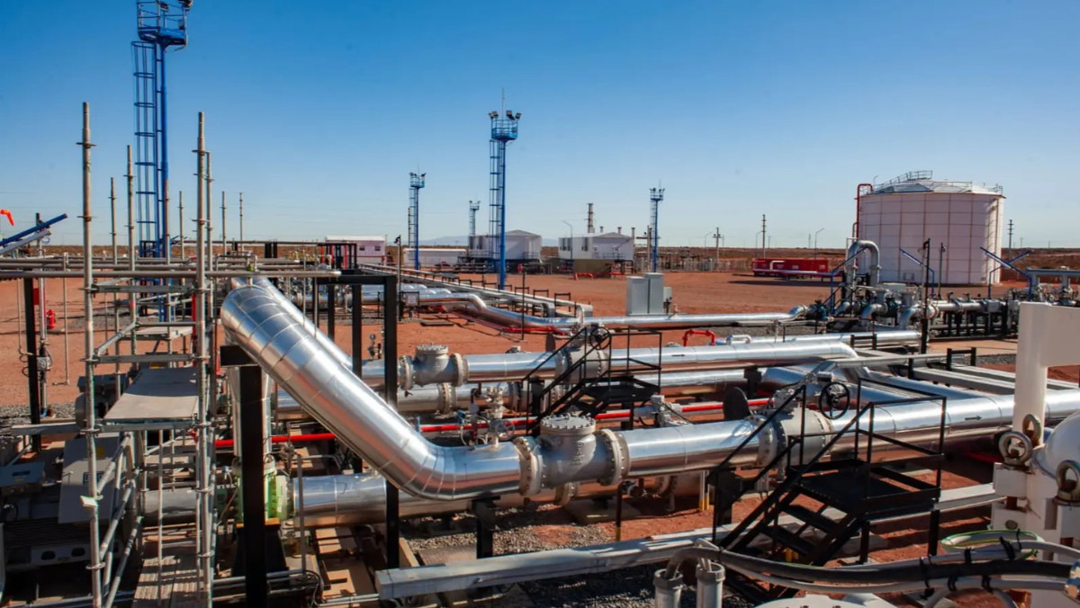 Pipeline infrastructure at a shale production site in Argentina under clear sky